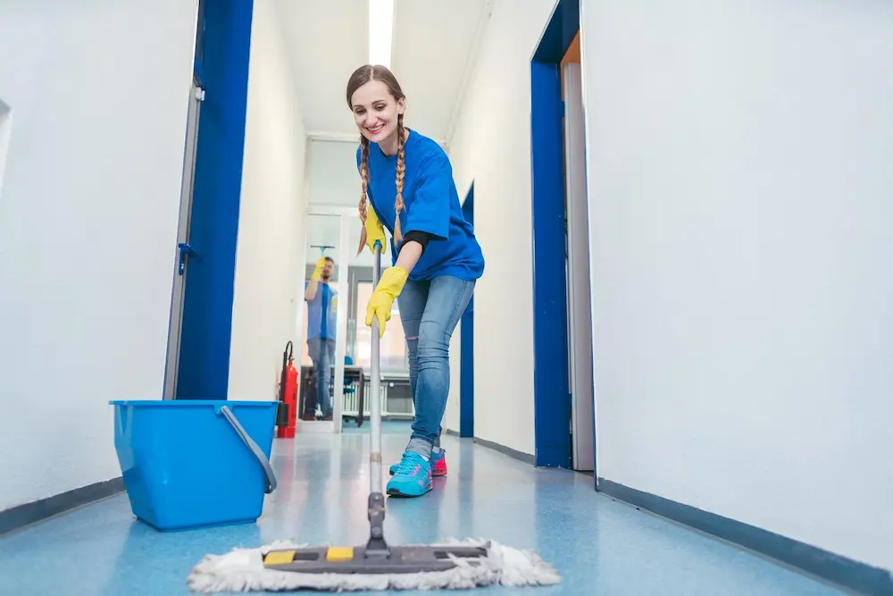 Image of a woman cleaning an office